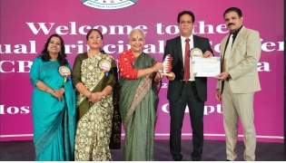 Acting Principal Mohammad Azam Khan receiving the award.