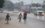 People walk in heavy rain in Harare, Zimbabwe, Jan. 24, 2026. (Str/Xinhua)