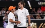 Germany's Alexander Zverev (R) and USA's Learner Tien embrace at the net after their men's singles quarter-final match on day ten of the Australian Open tennis tournament in Melbourne on January 27, 2026. (Photo by Izhar Khan / AFP) 