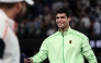 Spain's Carlos Alcaraz signs a television camera after beating Germany's Alexander Zverev in Melbourne on January 30, 2026. (Photo by Izhar Khan / AFP) 