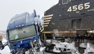This handout image released by the Gastonia Police Department shows a semi-truck struck by a freight train at the intersection of Poplar Street and Airline Avenue in Gastonia, north of downtown Charlotte, North Carolina on January 31, 2026 amid a winter snowstorm affecting the region. Photo by Gastonia Police Department / AFP