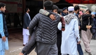 A man carries an injured boy to a hospital following an explosion at a mosque in Islamabad on February 6, 2026. (Photo by Aamir Qureshi / AFP)