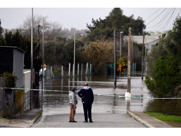Two people observe a flooded area at Las Pachecas settlement in Jerez, southern Spain, on February 5, 2026, amid Storm Leonardo. (Photo by Cristina Quicler / AFP)