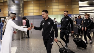 Sharjah players are welcomed upon their arrival in Doha.