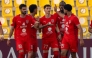 Al Duhail’s Adel Boulbina (centre) celebrates with teammates. 