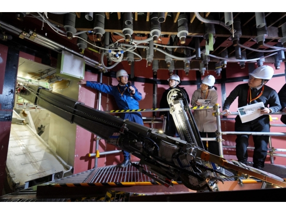A robotic arm demonstrates the removal of melted nuclear fuel debris during a simulation at the Fukushima Daiichi Nuclear Power Plant on February 25, 2026. (Photo by Japan Pool / JIJI PRESS / AFP) 