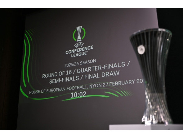 This photograph shows the UEFA Conference League Cup displayed next to a screen announcing the 2025-2026 UEFA Conference League round of 16, quarter-final and semi-final draw at the House of European Football in Nyon, western Switzerland on February 27, 2026. (Photo by Harold CUNNINGHAM / AFP)