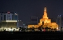 The illuminated Abdulla Bin Zaid al-Mahmud Islamic Cultural Center, also known as Fanar Mosque with the spiral-shaped minaret, is pictured at night in Doha on March 1, 2026. Photo by Karim Jaafar / AFP