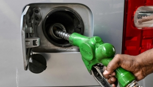 A worker refuels a car at a filling station in Dhaka on March 9, 2026. (Photo by Munir Uz Zaman / AFP)