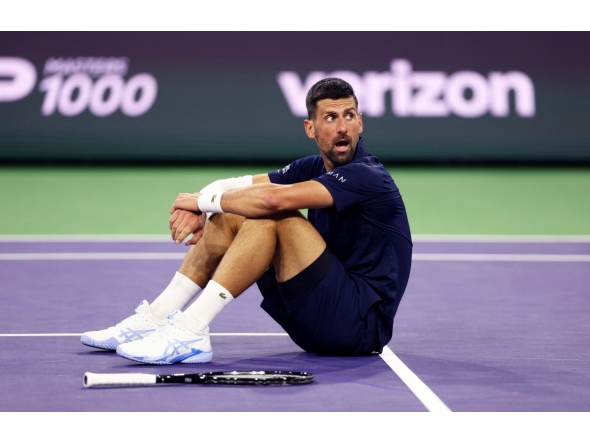 Novak Djokovic of Serbia sits up after falling to the court with exhaustion against Jack Draper of Great Britain in their fourth round match of the BNP Paribas Open at Indian Wells Tennis Garden on March 11, 2026, in Indian Wells, California.  (Photo by CLIVE BRUNSKILL / GETTY IMAGES NORTH AMERICA / Getty Images via AFP)