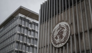 This photograph shows a logo of the World Health Organisation (WHO) displayed on the facade of organisation's headquarters in Geneva on April 23, 2025. Photo by Fabrice COFFRINI / AFP