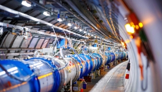TOSome of the 1232 dipole magnets that bend the path of accelerated protons are pictured in the Large Hadron Collider (LHC) in a tunnel of the European Organisation for Nuclear Research (CERN), during maintenance works on February 6, 2020 in Echenevex, France, near Geneva. Photo by VALENTIN FLAURAUD / AFP