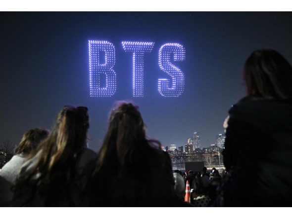 Drones illuminate the night sky with BTS logo during a drone light show at a riverside park in Seoul on March 20, 2026, ahead of the comeback concert of K-pop boy band BTS. Photo by Jung Yeon-je / AFP