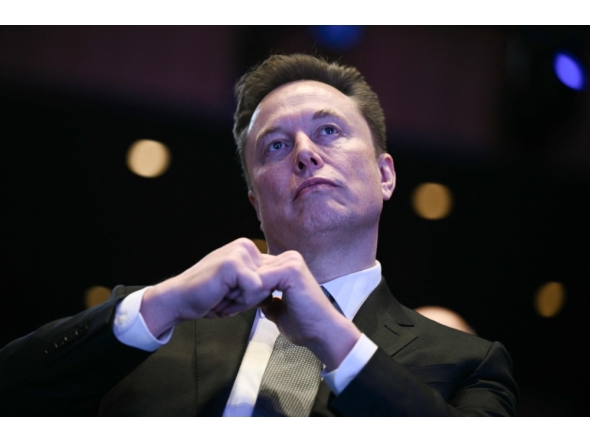 (Files) Elon Musk looks on at the John F. Kennedy Center for the Performing Arts in Washington, DC on November 19, 2025. (Photo by Brendan Smialowski / AFP)