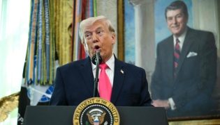 US President Donald Trump speaks before swearing in the new Secretary of Homeland Security Markwayne Mullin in the Oval Office of the White House in Washington, DC, on March 24, 2026. (Photo by Jim WATSON / AFP)

