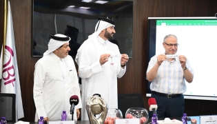 Officials pick teams during the draw ceremony for the 13th Qatar Cup basketball tournament.