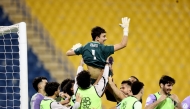 Muaither's goalkeeper Majed Abdullatif is tossed in the air as players celebrate their win over Al Arabi in the semi-final.