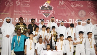 Al Wajba players celebrate with the trophy. Chairman of the Organising Committee Hassan Ali Al Ishaq and Tournament Director Youssef Ali Abdul Noor are also present.   