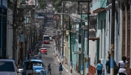 People walk down a street in Matanzas, Cuba, on March 31, 2026. (Photo by Yamil Lage / AFP)