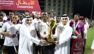 QSL CEO Hani Taleb Ballan presents the winner's trophy to Al Riffa captain.