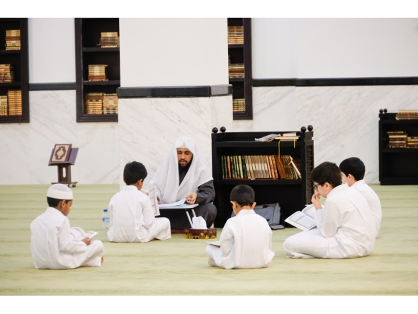 Children learn Quran recitation at a mosque.  