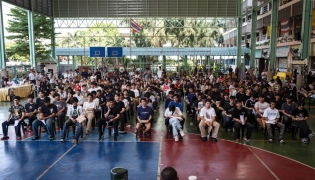 A group of men wait for the drawing of the Thai military conscription lottery at Watmatchantikaram School in Bangkok on April 7, 2026. (Photo by Chanakarn Laosarakham / AFP)