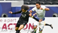 Al Sadd's Akram Afif (left) controls the ball