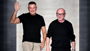 Italian stylists Domenico Dolce (R) and Stefano Gabbana (L) salute the audience at the end of the Dolce & Gabbana women's ready-to-wear Fall/Winter 2026 collection show as part of the Milan Fashion Week, in Milan on February 28, 2026. Photo by Miguel MEDINA / AFP