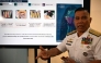 Philippine Navy spokesman Rear Admiral Roy Vincent Trinidad speaks next to a slide presentation of seized yellow bottles suspected to contain cyanide in waters of Second Thomas Shoal in the disputed South China Sea, during a press conference in Manila on April 13, 2026. Photo by Ted ALJIBE / AFP