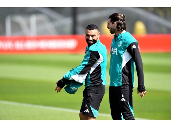 Liverpool's Egyptian striker #11 Mohamed Salah and Liverpool's Hungarian midfielder #08 Dominik Szoboszlai (R) attend a team training session at their training ground in Kirkby, Liverpool, north-west England on April 13, 2026, on the eve of their UEFA Champions League, quarter final second leg football match against Paris Saint-Germain. (Photo by PETER POWELL / AFP)