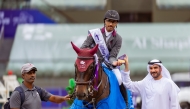 President of Regional Group VII of the International Federation for Equestrian Sports Sultan Mohammed Al-Yahyaei presents the trophy to Qatar’s Saad Ahmed Al Saad. 