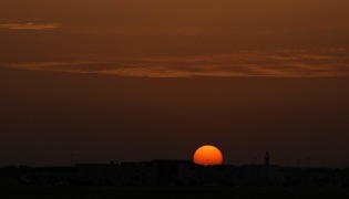 The sun sets over the city of Doha on April 17, 2026. (Photo by AFP)