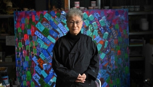 This picture taken on March 4, 2026, shows South Korean sculptor Kim Yun Shin dressed in overalls posing for a photo during an interview with AFP at her studio in Paju. Photo by Jung Yeon-je / AFP)