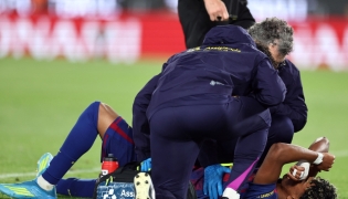 Barcelona's Spanish forward #10 Lamine Yamal receives medical attention after sustaining an injury during the Spanish league football match between FC Barcelona and RC Celta de Vigo at Camp Nou stadium in Barcelona on April 22, 2026. (Photo by Josep Lago / AFP)