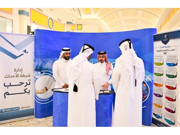 Visitors interacting with an MoI representative at the exhibition.