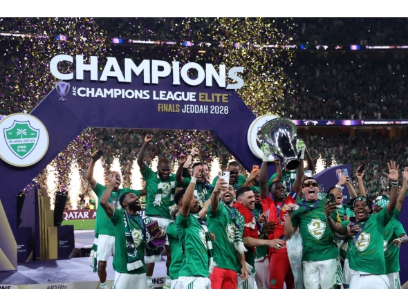 Al-Ahli players celebrate with the trophy after beating Machida Zelvia 1-0 in the final of the AFC Champions League football match between Al-Ahli Saudi FC and FC Machida Zelvia at the King Abdullah Sports City, in Jeddah on April 25, 2026. (Photo by Abdel Ghani BASHIR / AFP)