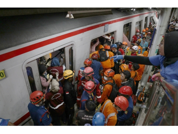 Rescuers work at the train accident site in Bekasi, Indonesia. A commuter train on the Jakarta-Bekasi route was involved in a collision with a long-distance train operating on the Jakarta-Surabaya route at around 8:50pm local time on Monday. (Photo by B. Nugraha/Xinhua)