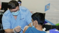 A PHCC nurse administering vaccine for a patient