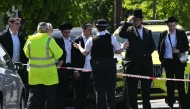 TOPSHOT-BRITAIN-CRIME-POLICE-RELIGION
Local residents look on from outside a cordoned off area in the Golders Green neighbourhood of north London on April 29, 2026, following the stabbing to two people nearby.
 (Photo by JUSTIN TALLIS / AFP)