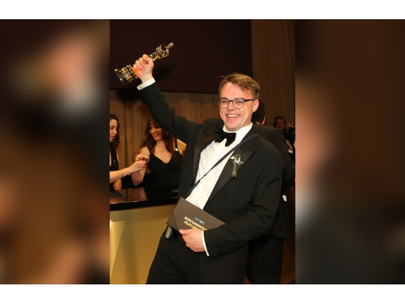 Russian teacher Pavel Talankin hoists his Oscar for Best Documentary Feature Film for 