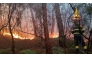 This photo taken and handout on May 1, 2026 by the Vigili del Fuoco, the Italian Corps. of Firefighters, shows firefighters trying to extinguish a major fire on Mount Faeta in the area between the provinces of Lucca and Pisa in the Tuscany region. (Photo by HANDOUT / Vigili del Fuoco / AFP) 