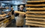 An employee works in a bakery in Quimper, western France, on May 1, 2026. Photo by Fred TANNEAU / AFP