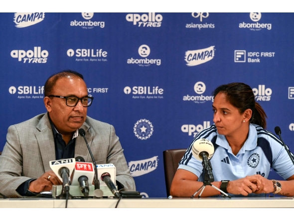 Indian women's cricket captain Harmanpreet Kaur (R) listens to BCCI Secretary Devajit Saikia announcing the squad for the upcoming ICC Women's T20 World Cup and tour of England, in Mumbai on May 2, 2026. (Photo by Indranil MUKHERJEE / AFP)
