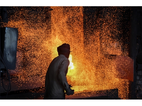 A labourer works at an iron factory in Lahore on April 30, 2026. (Photo by Arif ALI / AFP)
