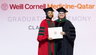 Dr. Moune Jabre presents class valedictorian Dr. Lina Ahmed with her diploma. 