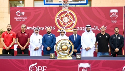 Qatar Basketball Federation, Al Arabi and Al Sadd officials, along with players pose for a photo.