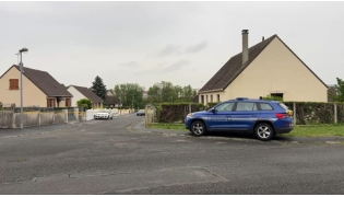 This screengrab made from an AFP video shows a gendarmerie car parked in a street in Fere-en-Tardenois, northern France. (Photo by Noorullah Shirzada / AFP)