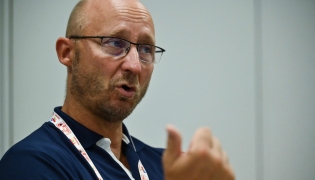 This photo taken on August 23, 2022 shows Badminton World Federation (BWF) secretary general Thomas Lund of Denmark speaking during an interview with AFP on the sidelines of the Badminton World Championships in Tokyo. Photo by Richard A. Brooks / AFP