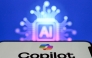 A photo taken on May 7, 2026 shows the letters AI for Artificial Intelligence on a laptop screen (top) next to the logo of the Microsoft's Copilot chatbot application on a smartphone screen in Frankfurt am Main, western Germany. (Photo by Kirill KUDRYAVTSEV / AFP)