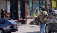 Police stand in a cordoned off area near a bank where suspects have taken multiple hostages in the western German town of Sinzig, on May 8, 2026. (Photo by Thomas Frey / DPA / AFP) 